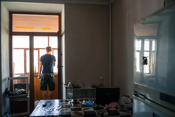 Mikael brushing his teeth on the balcony of the Kazan lodging.